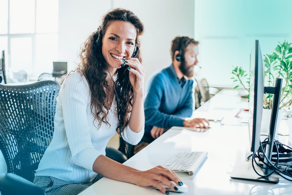 A photo of a woman talking on a phone headset